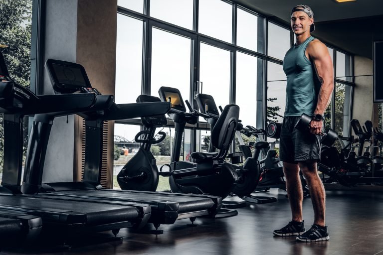 man has training with dumbbells at gym